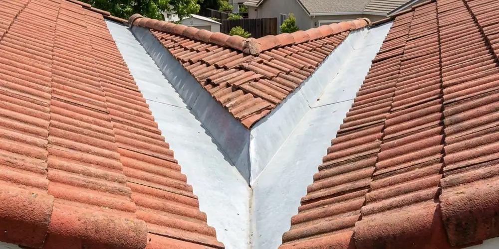 Tile roof valley cleared after gutter cleaning in Auburn