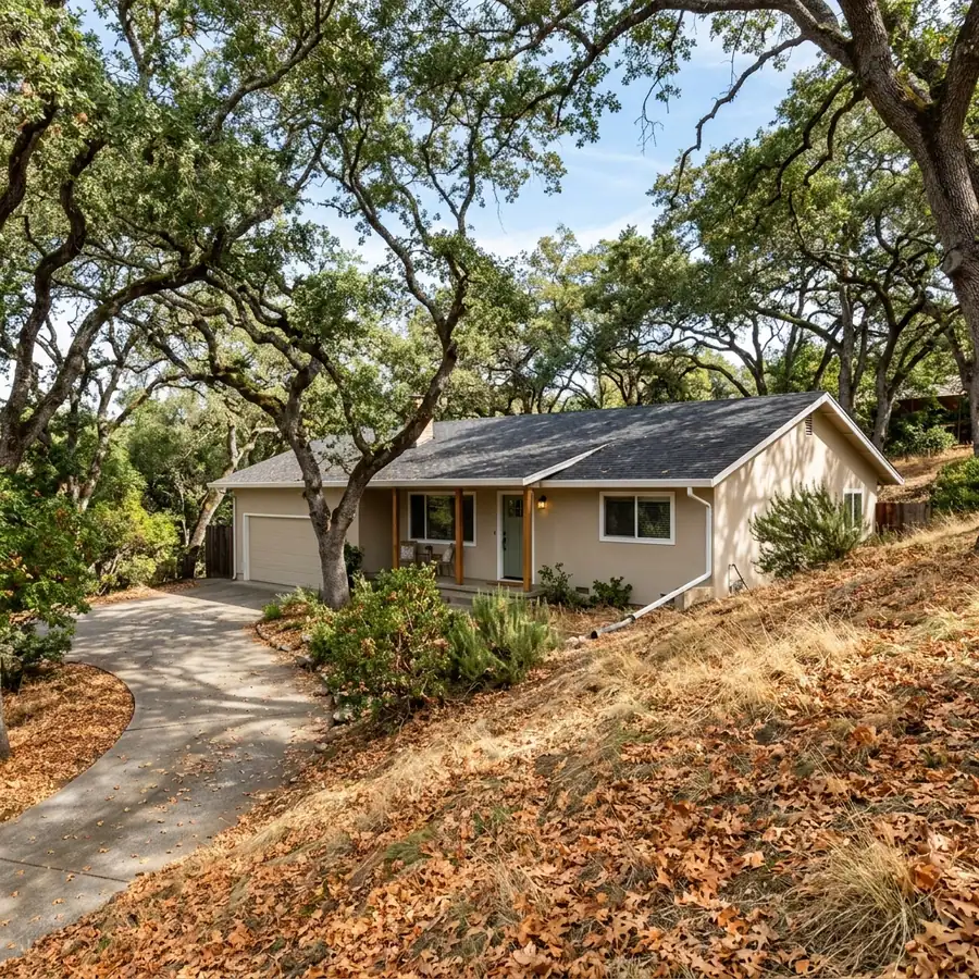 Orangevale ranch home on a sloped lot under decades old oak canopy — gutter cleaning in Orangevale